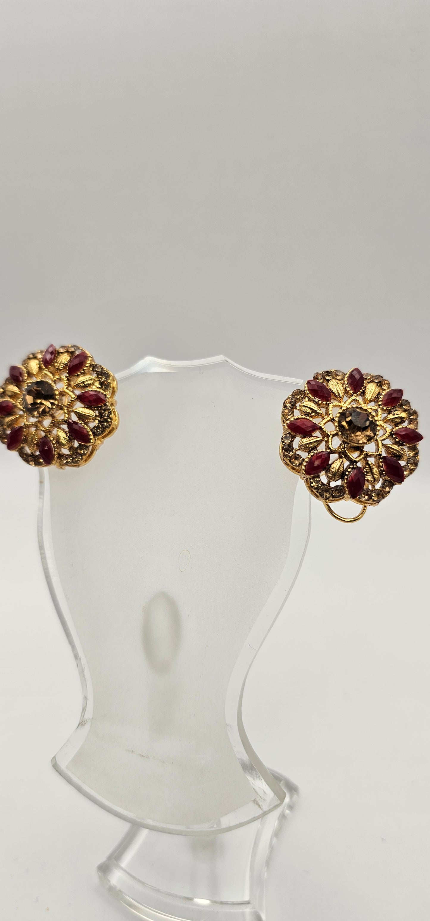 Pair of earrings from Villandi comes together with a beautifully delicate floral pattern, decorated with an interplay of rubies and diamonds