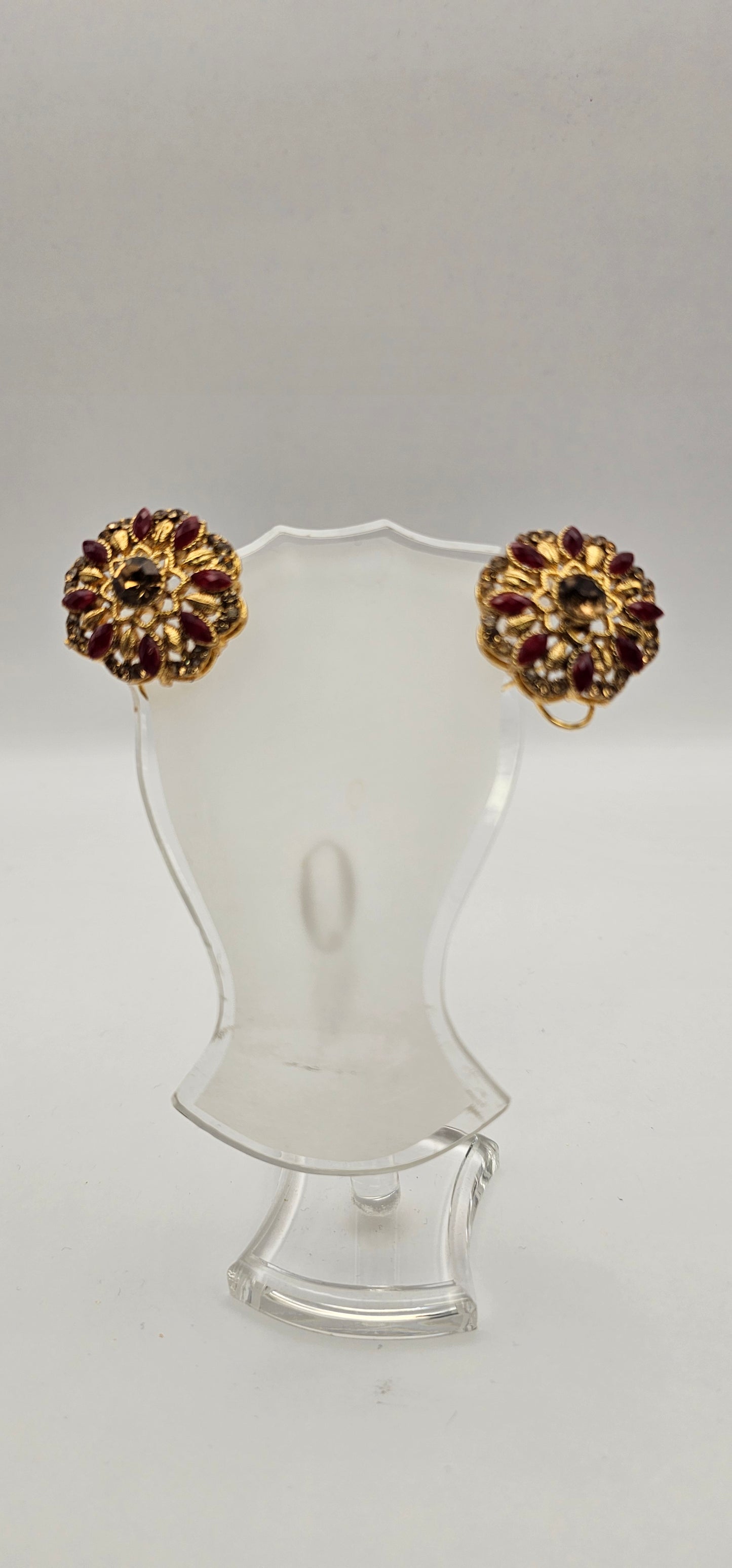 Pair of earrings from Villandi comes together with a beautifully delicate floral pattern, decorated with an interplay of rubies and diamonds