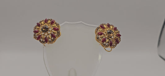 Pair of earrings from Villandi comes together with a beautifully delicate floral pattern, decorated with an interplay of rubies and diamonds